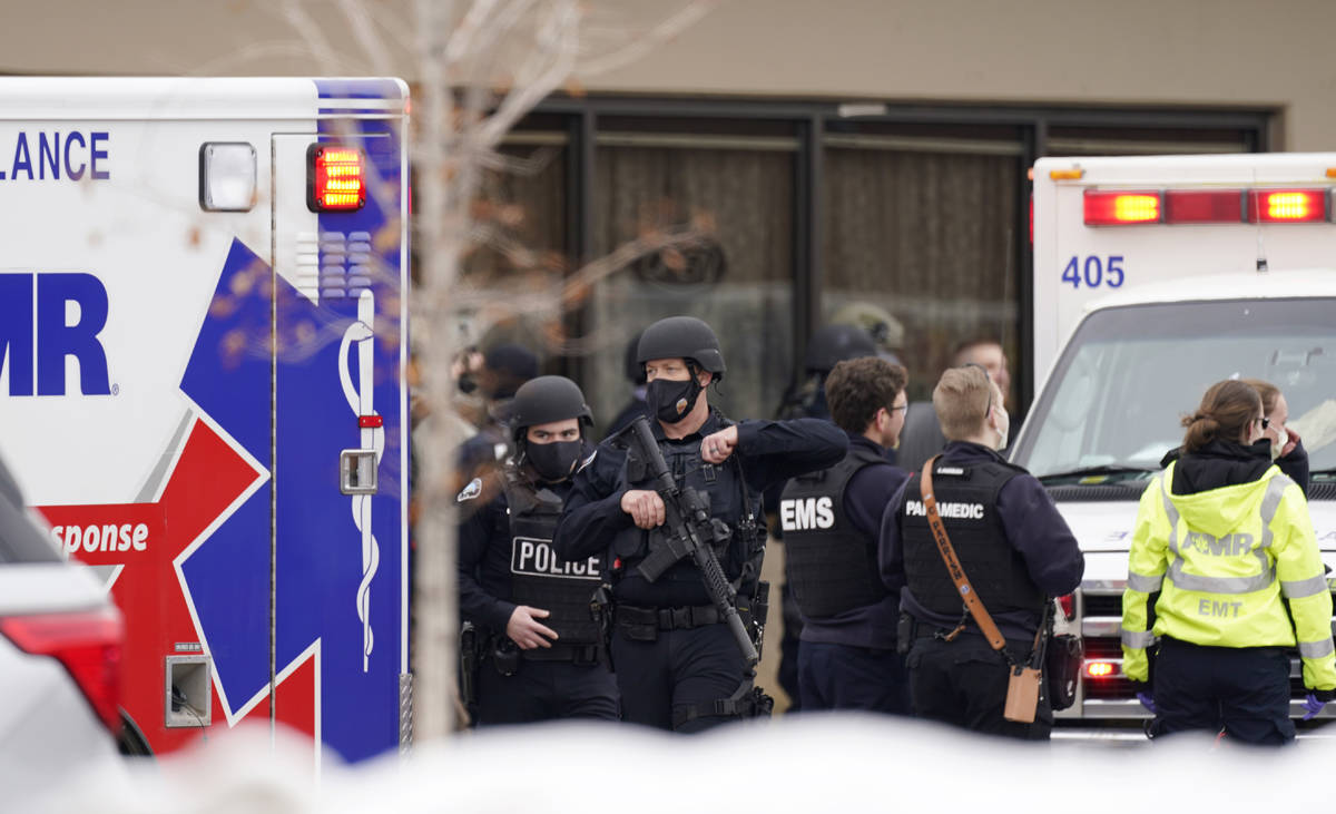 Police work on the scene outside a King Soopers grocery store where a shooting took place Monda ...