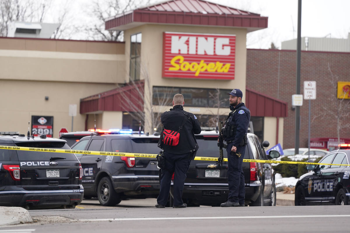 Police work on the scene outside of a King Soopers grocery store where a shooting took place Mo ...