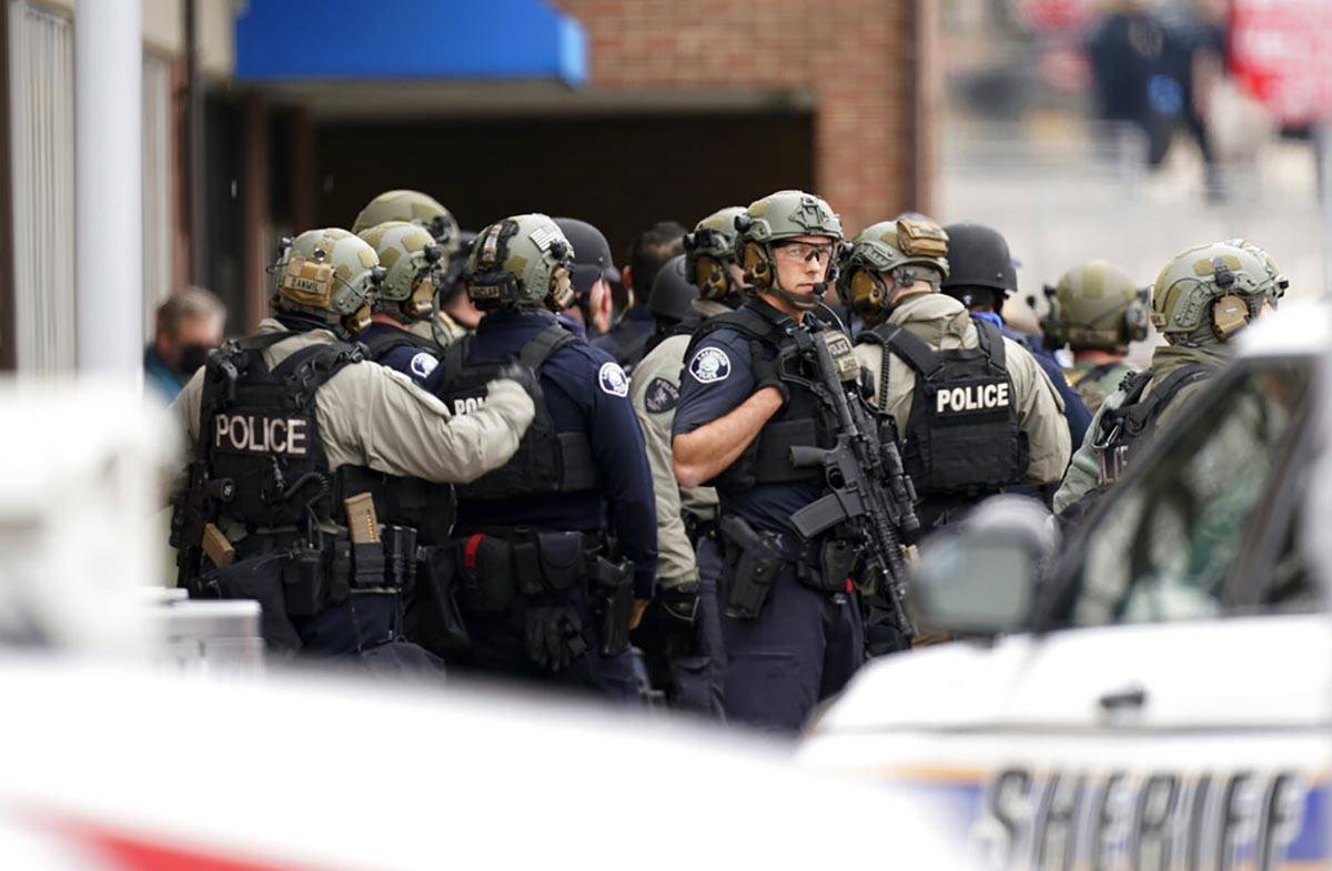 Police stand outside a King Soopers grocery store where authorities say multiple people have be ...