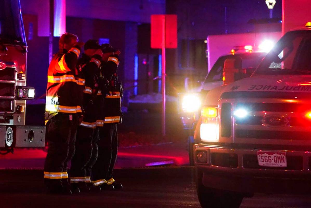 Firefighters salute an ambulance as it leaves a King Soopers grocery store where authorities sa ...