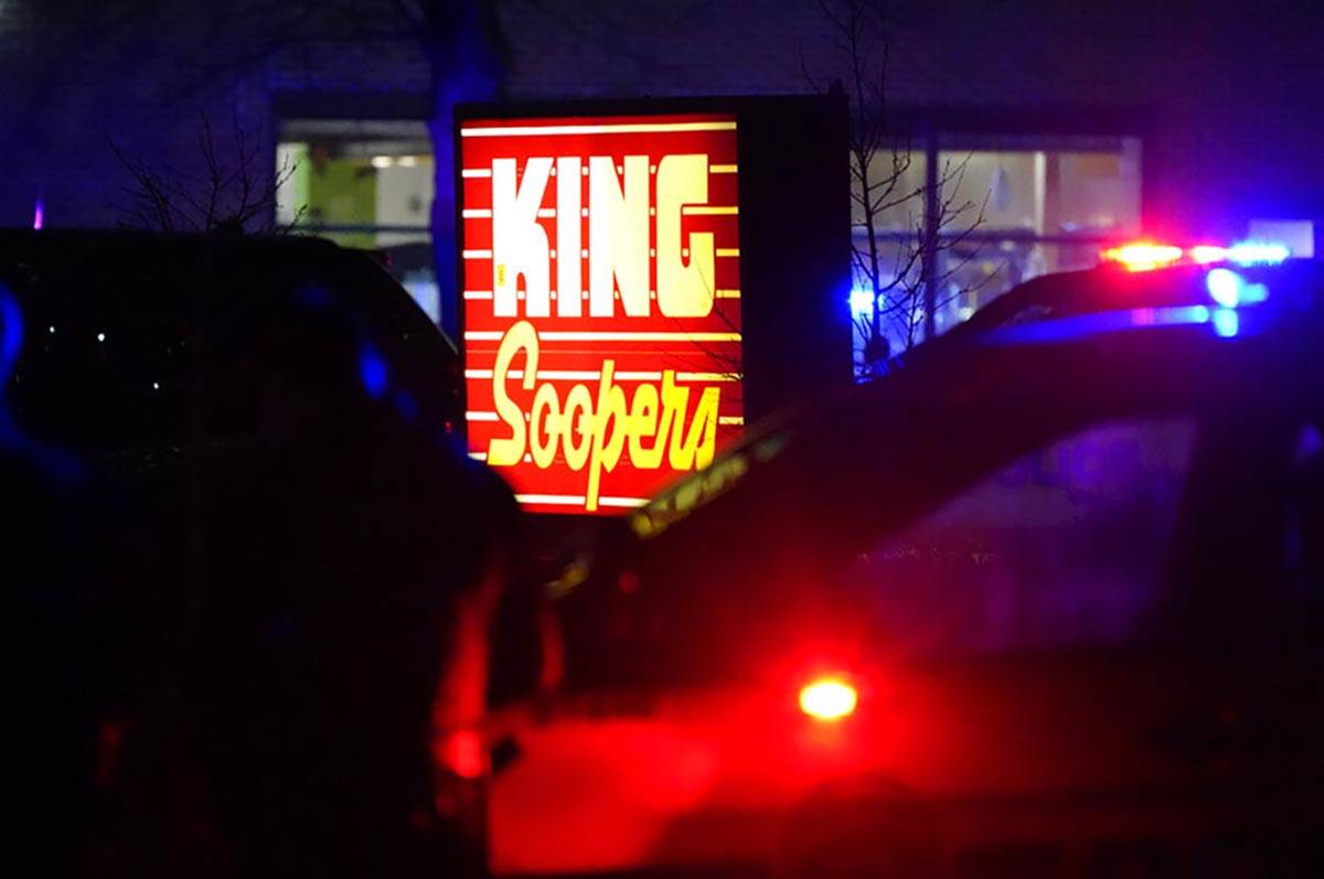 Police stand guard outside a King Soopers grocery store where authorities say multiple people w ...