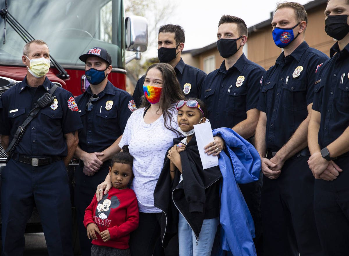 Lynn Armstrong, center, poses with her grandchildren Michael Robinson, 4, left, and Karlycia Os ...