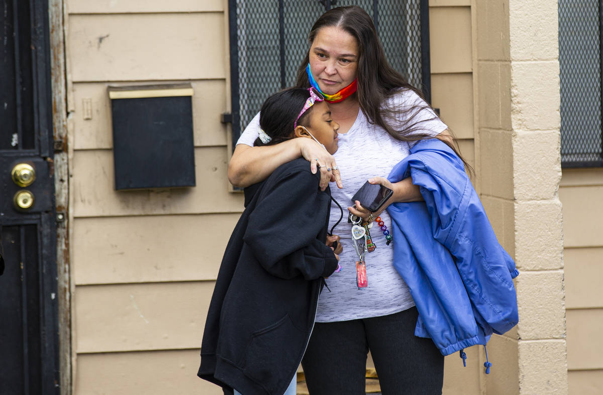 Lynn Armstrong embraces her granddaughter, Karlycia Osorio, 8, during a visit with the firefigh ...