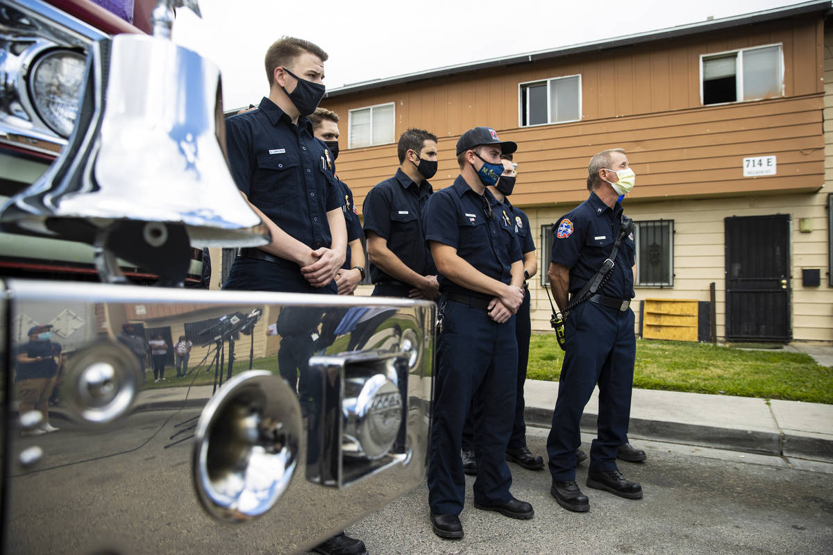 North Vegas Fire Department firefighters gather to meet the family they helped assist after a f ...