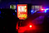 Police stand guard outside a King Soopers grocery store where authorities say multiple people w ...