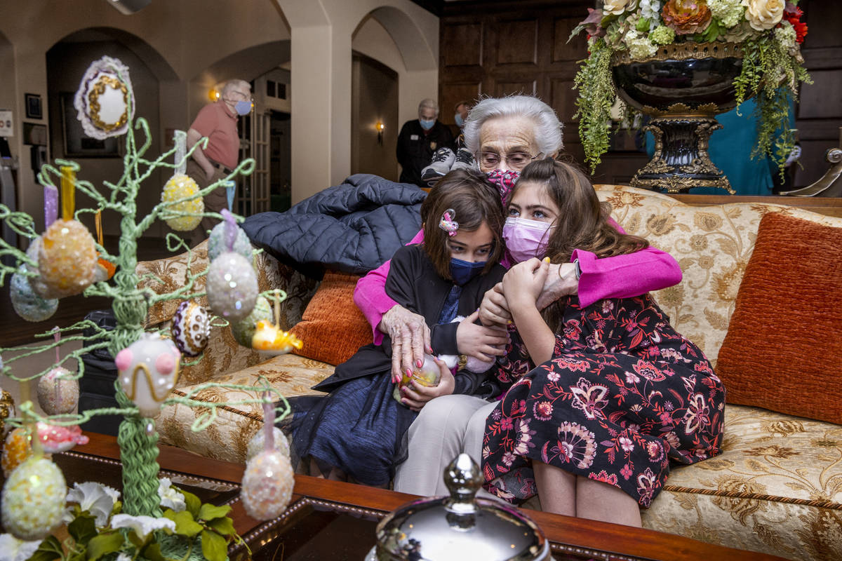 Ellie Levi, 90, center, hugs her great-granddaughters Emery Cuthbert, 6, left, and Hailey Cuthb ...