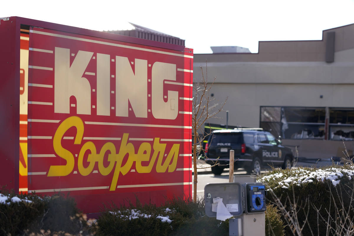 Police vehicles sit in the parking lot outside a King Soopers grocery store where a mass shooti ...