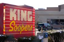Police vehicles sit in the parking lot outside a King Soopers grocery store where a mass shooti ...