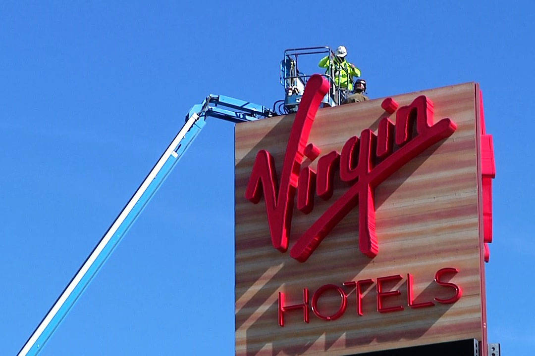 Construction continues as workers are lifted up to a sign on Feb. 11, 2021, at the Virgin Hotel ...