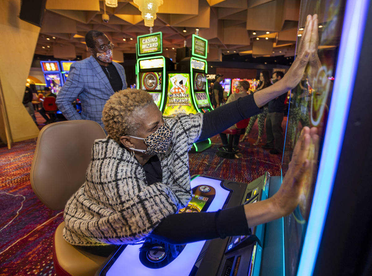 Noreen McRoyal gets her hands onto the Abundant Fortune slot machine for extra luck as her husb ...
