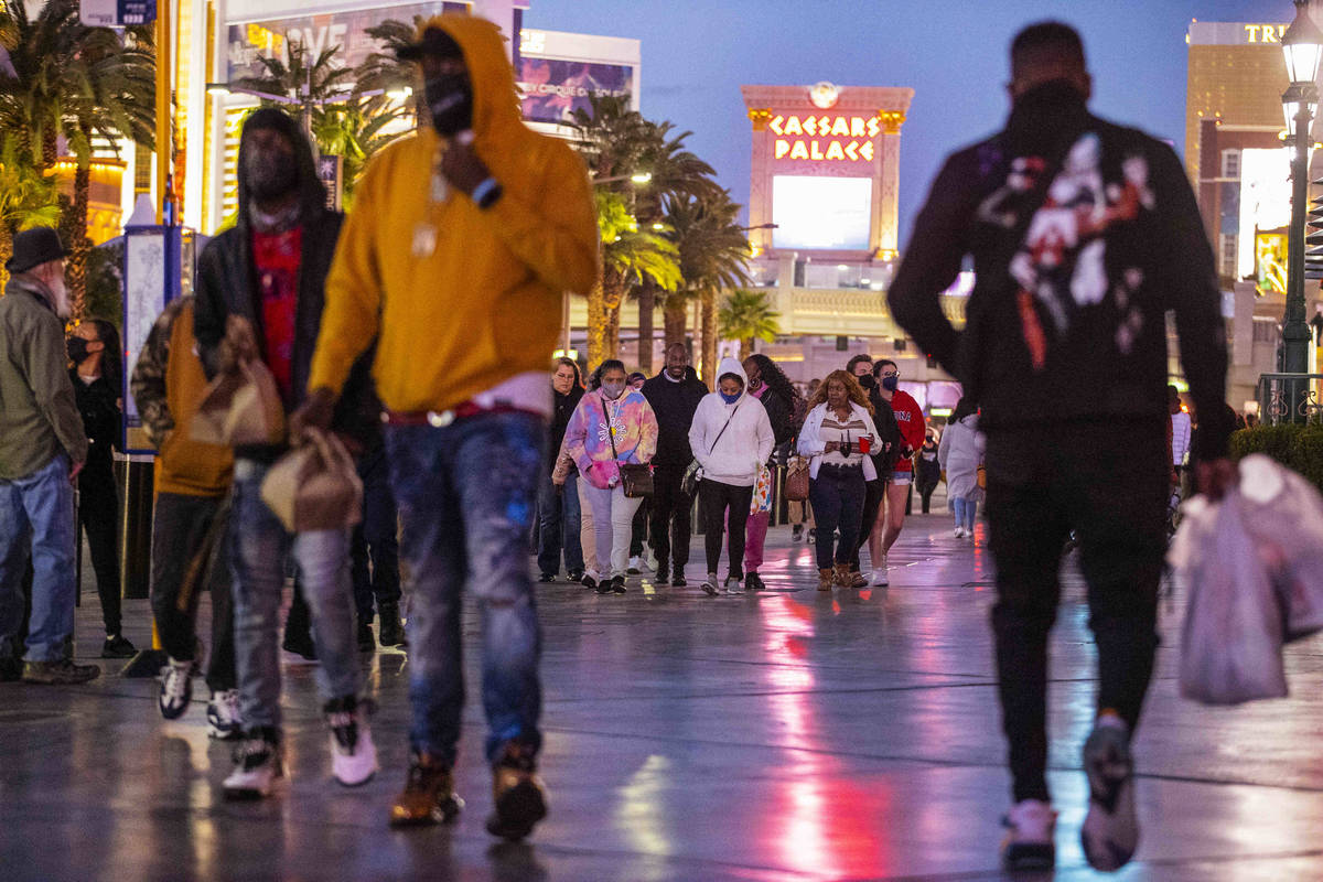 People visit the Strip near the Paris Las Vegas hotel-casino in Las Vegas, on Saturday, Feb. 2 ...