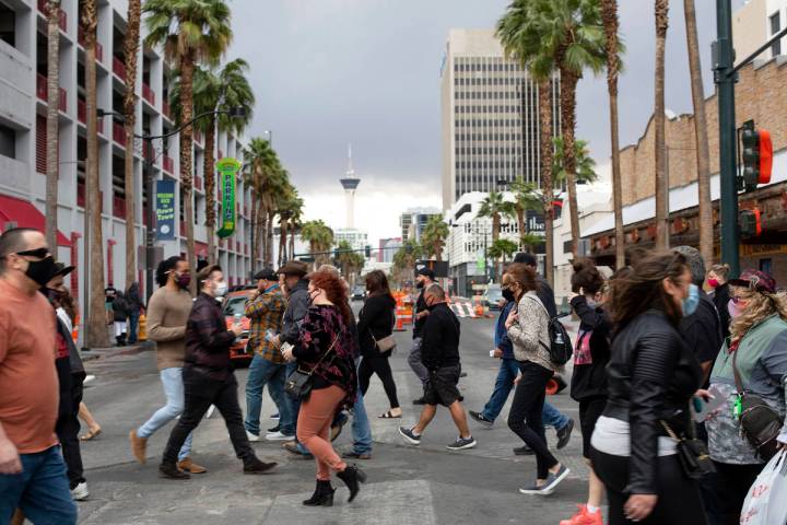 Visitors to Fremont Street Experience cross 4th Street after Clark County on Saturday, Feb. 13, ...