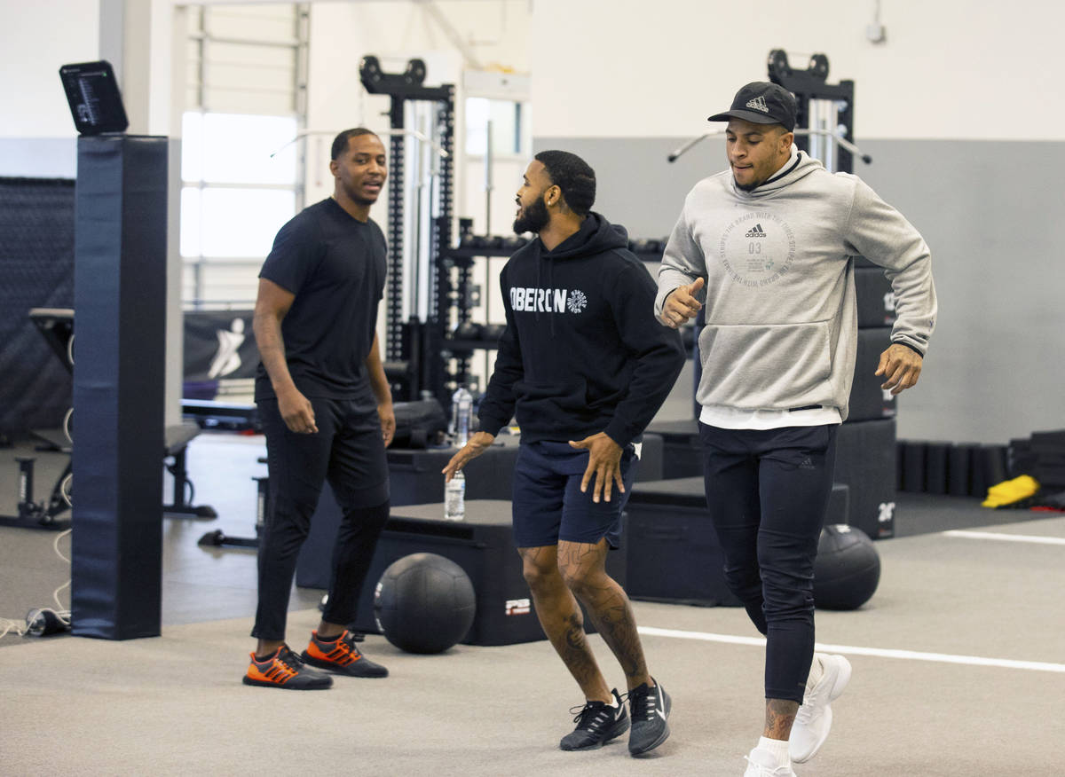 Las Vegas Raiders cornerback Keisean Nixon, center, and safety Johnathan Abram warm up before t ...