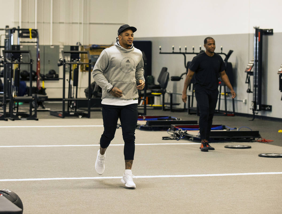 Las Vegas Raiders safety Johnathan Abram warms up before his workout with Deon Hodges, right, h ...