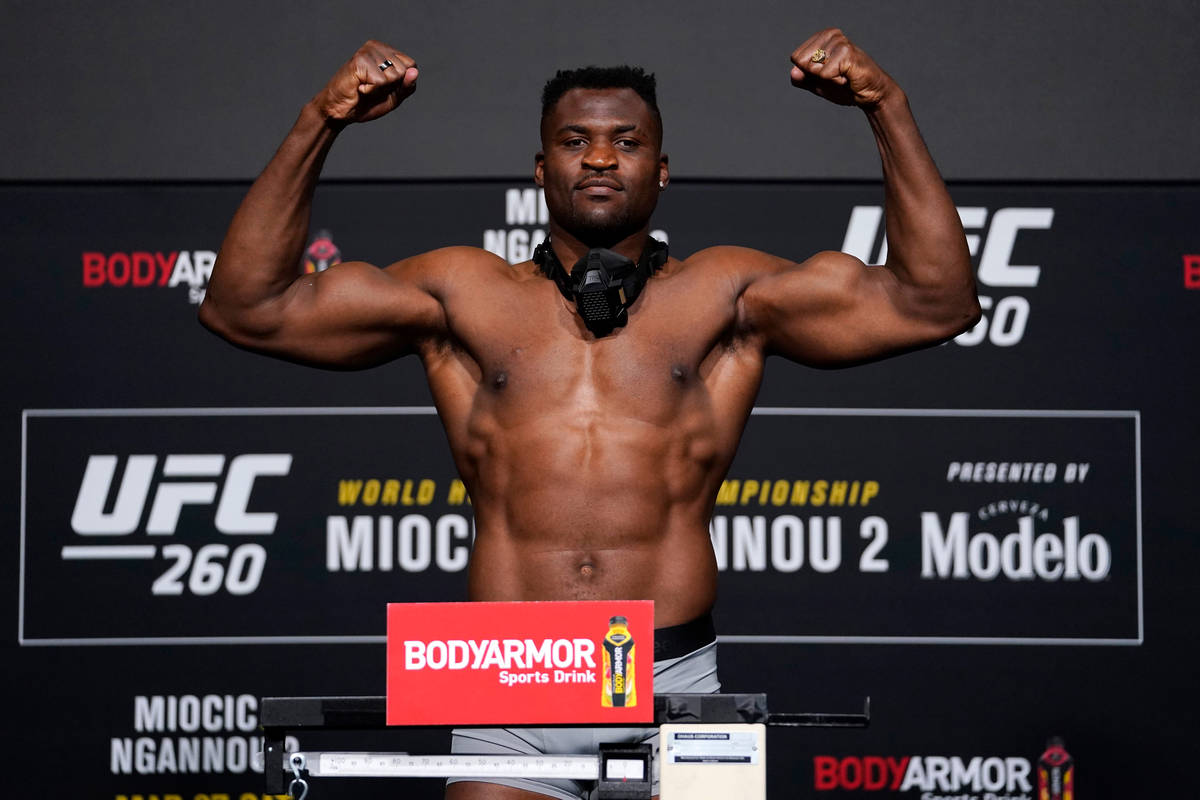 Francis Ngannou of Cameroon poses on the scale during the UFC 260 weigh-in at UFC APEX on March ...