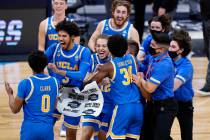 UCLA players celebrate after beating Alabama 88-78 in overtime of a Sweet 16 game in the NCAA m ...