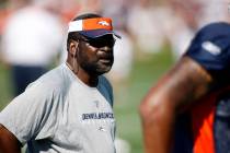 Denver Broncos defensive lines coach Wayne Nunnely looks on as players take part in drills duri ...