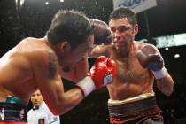 Boxer Manny Pacquiao, left, takes a blow from his opponent Oscar De La Hoya during their welter ...