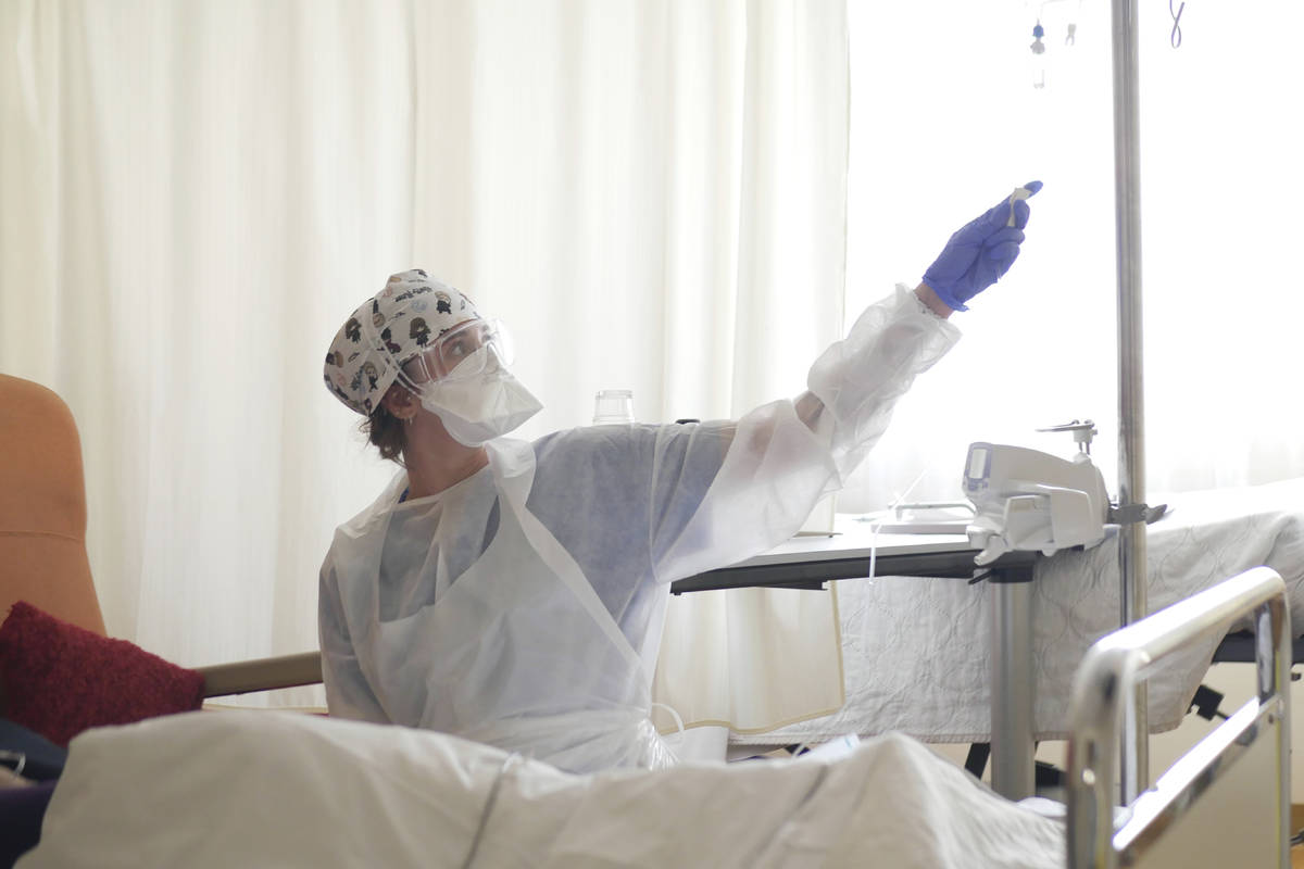 FILE- In this March 19, 2021, file photo, a nurse tends to a patient affected by COVID-19 virus ...