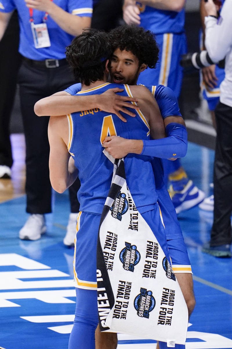 UCLA guard Johnny Juzang (3) hugs Jaime Jaquez Jr. (4) after beating Alabama 88-78 in overtime ...