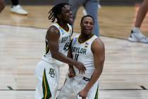 Baylor guard Davion Mitchell (45) and Mark Vital (11) celebrate after beating Arkansas 81-72 du ...