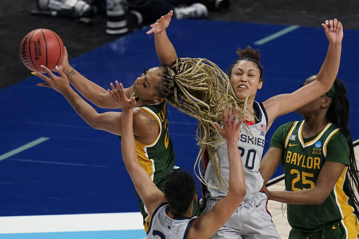 Baylor guard DiJonai Carrington, left, drives to the basket against UConn forward Olivia Nelson ...