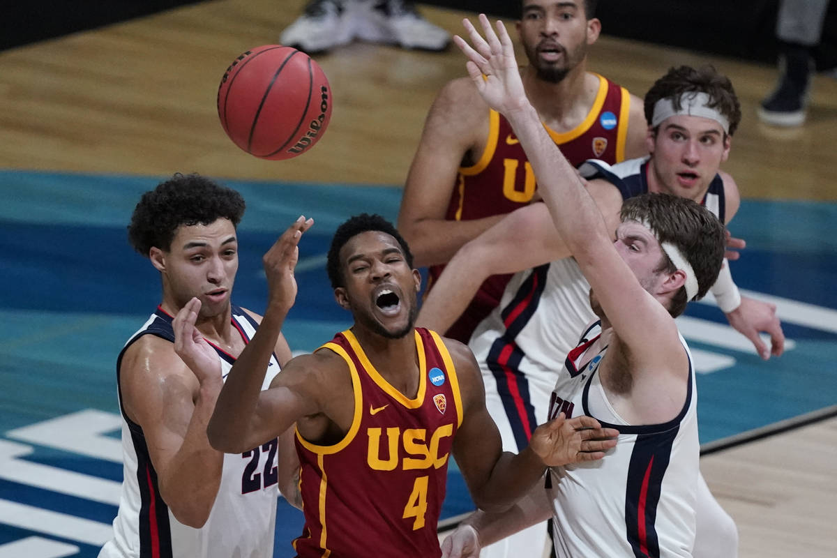 Southern California forward Evan Mobley (4) loses the ball between Gonzaga forward Anton Watson ...