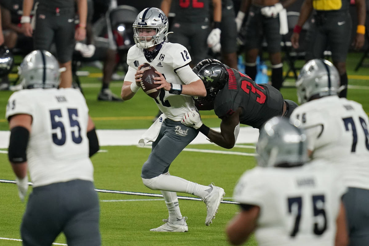 UNLV linebacker Jacoby Windmon (35) sacks Nevada quarterback Carson Strong (12) during the firs ...