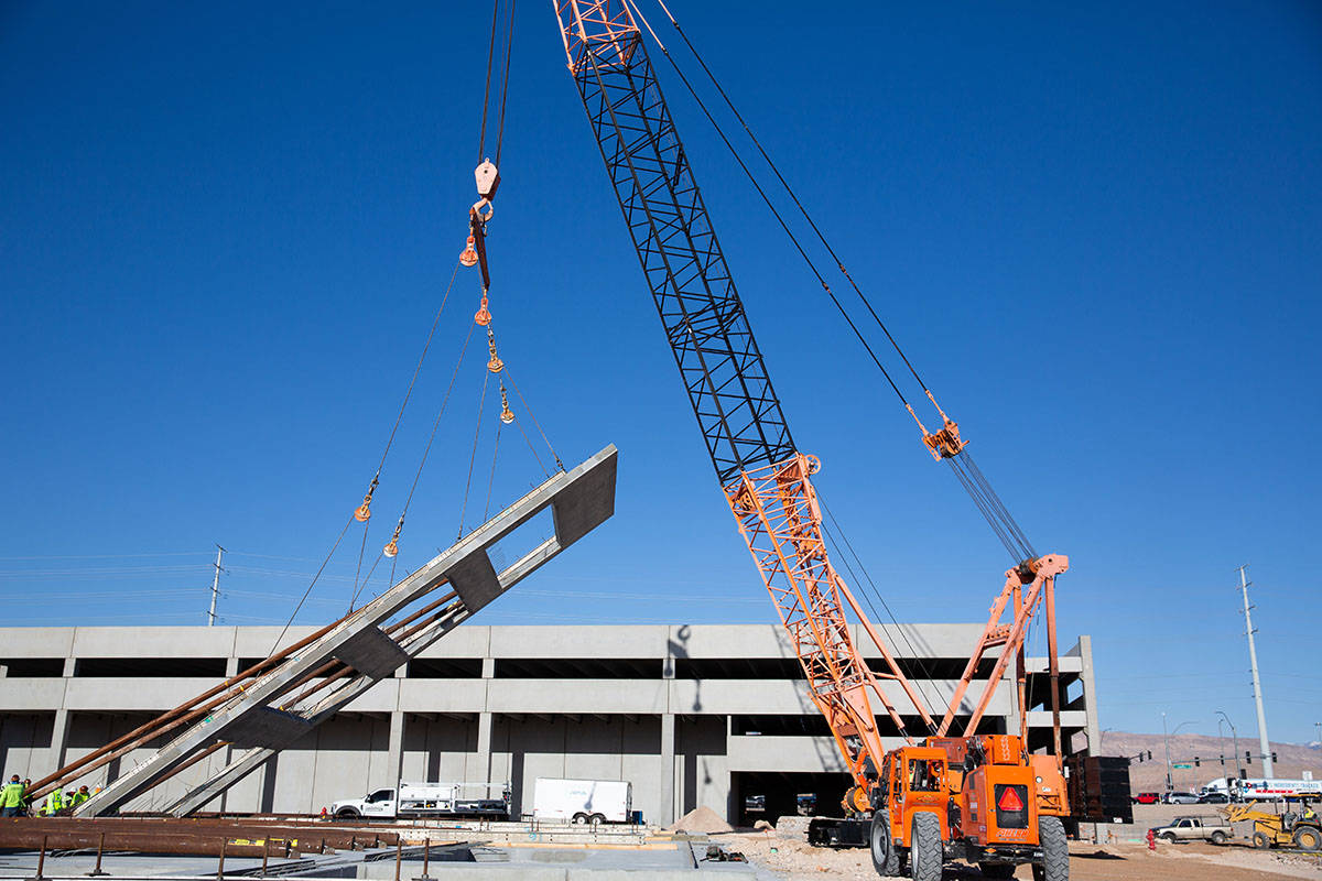 Crews begin lifting walls Monday, March 29, 2021, for the mixed-use development project UnCommo ...