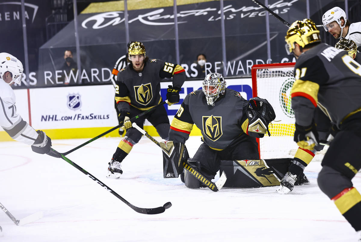 Golden Knights goaltender Robin Lehner (90) defends the net as Los Angeles Kings' Austin Strand ...