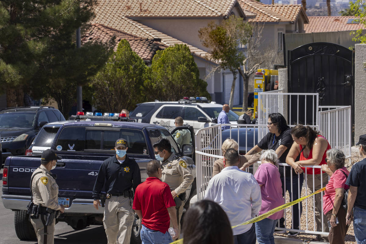 Family members and friends come together down the block as the Clark County Fire Department and ...