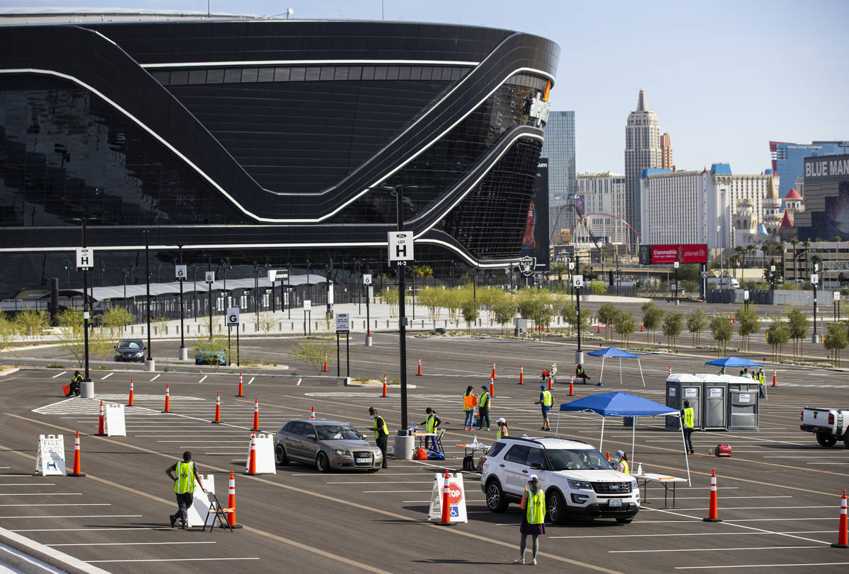 People check in to get tested at the drive-thru COVID-19 testing site at Allegiant Stadium in L ...