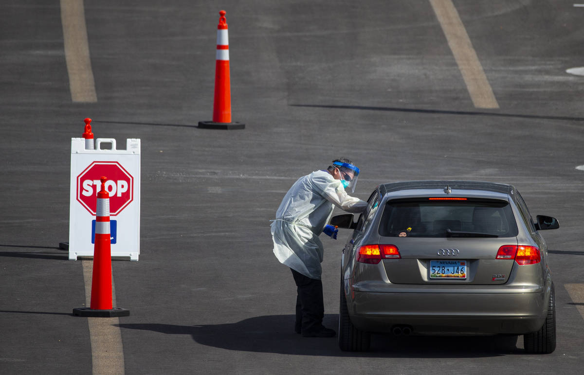 Tests for COVID-19 are conducted at the testing site at Allegiant Stadium in Las Vegas on Wedne ...