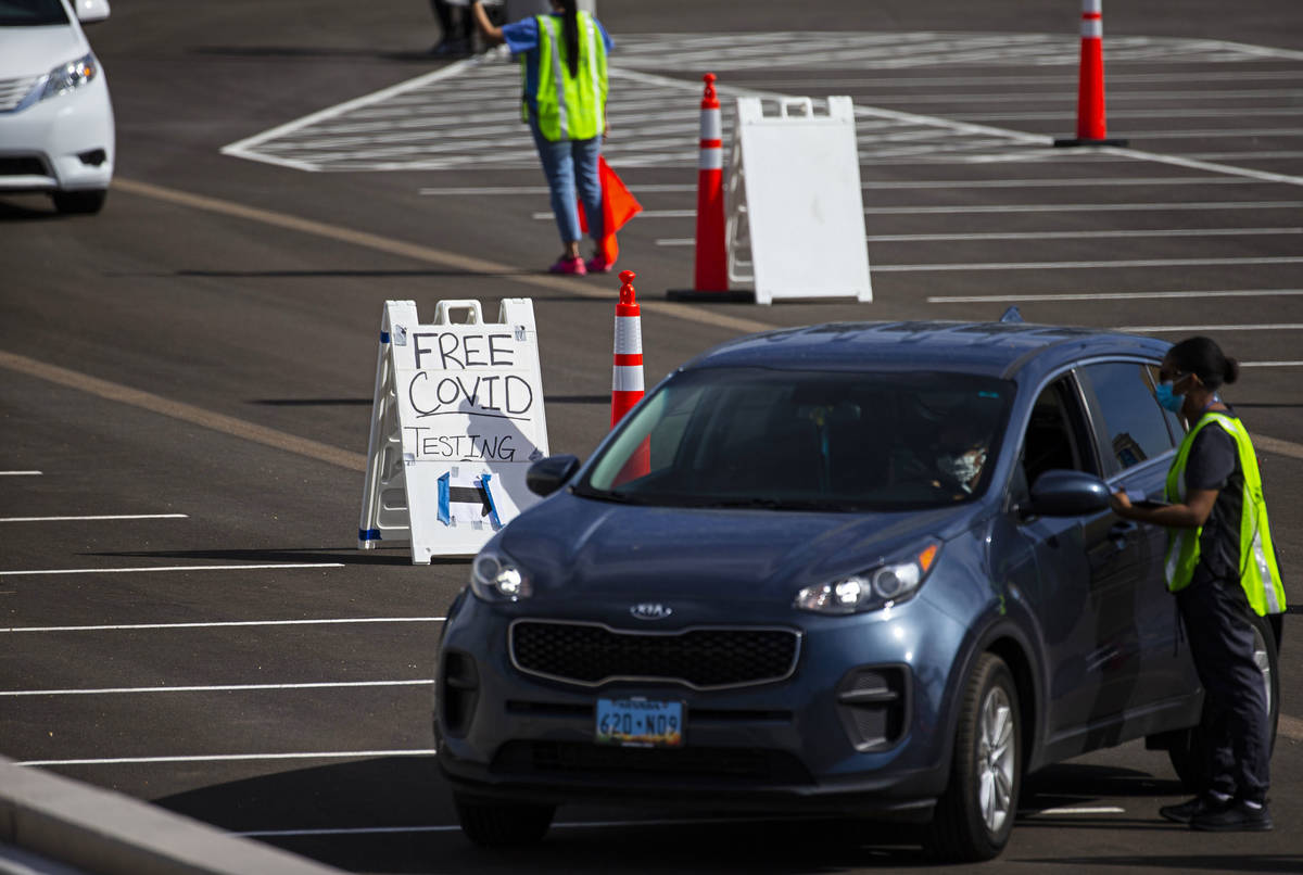 People check in to get tested at the drive-thru COVID-19 testing site at Allegiant Stadium in L ...