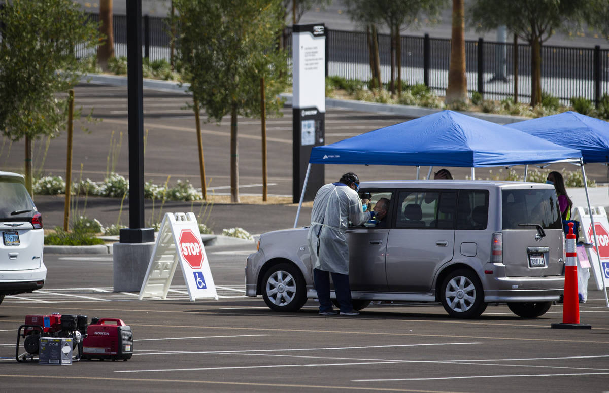 Tests for COVID-19 are conducted at the testing site at Allegiant Stadium in Las Vegas on Wedne ...