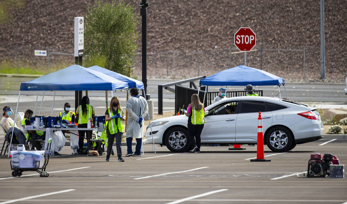 Tests for COVID-19 are conducted at the testing site at Allegiant Stadium in Las Vegas on Wedne ...