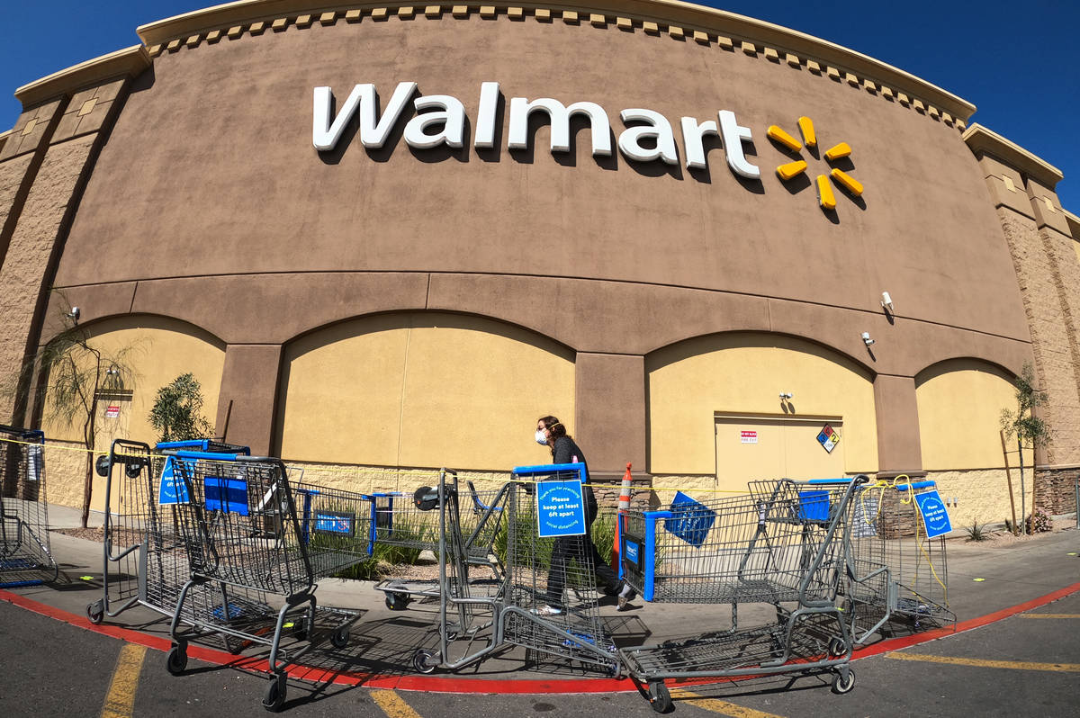 Shopping carts are lined up as barriers leading to the entrance of Walmart Supercenter, 3950 W ...