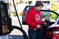 Brandon Edester pumps gas at a 7-Eleven on Monday, March, 15, 2021, in Las Vegas. (Bizuayehu Te ...