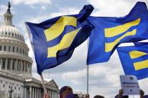 In this July 26, 2017, file photo, people with the Human Rights Campaign hold up "equality flag ...