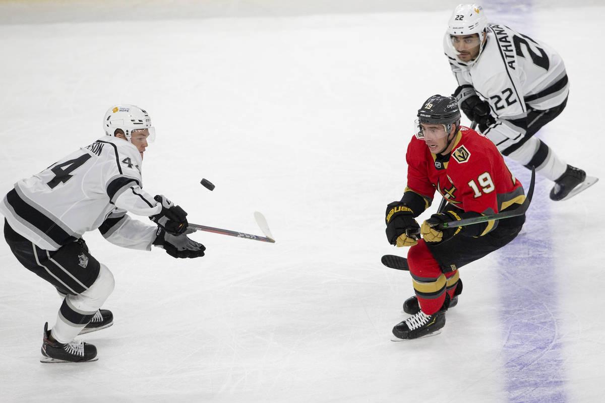 Golden Knights right wing Reilly Smith (19) and Kings left wing Andreas Athanasiou (22) eye the ...