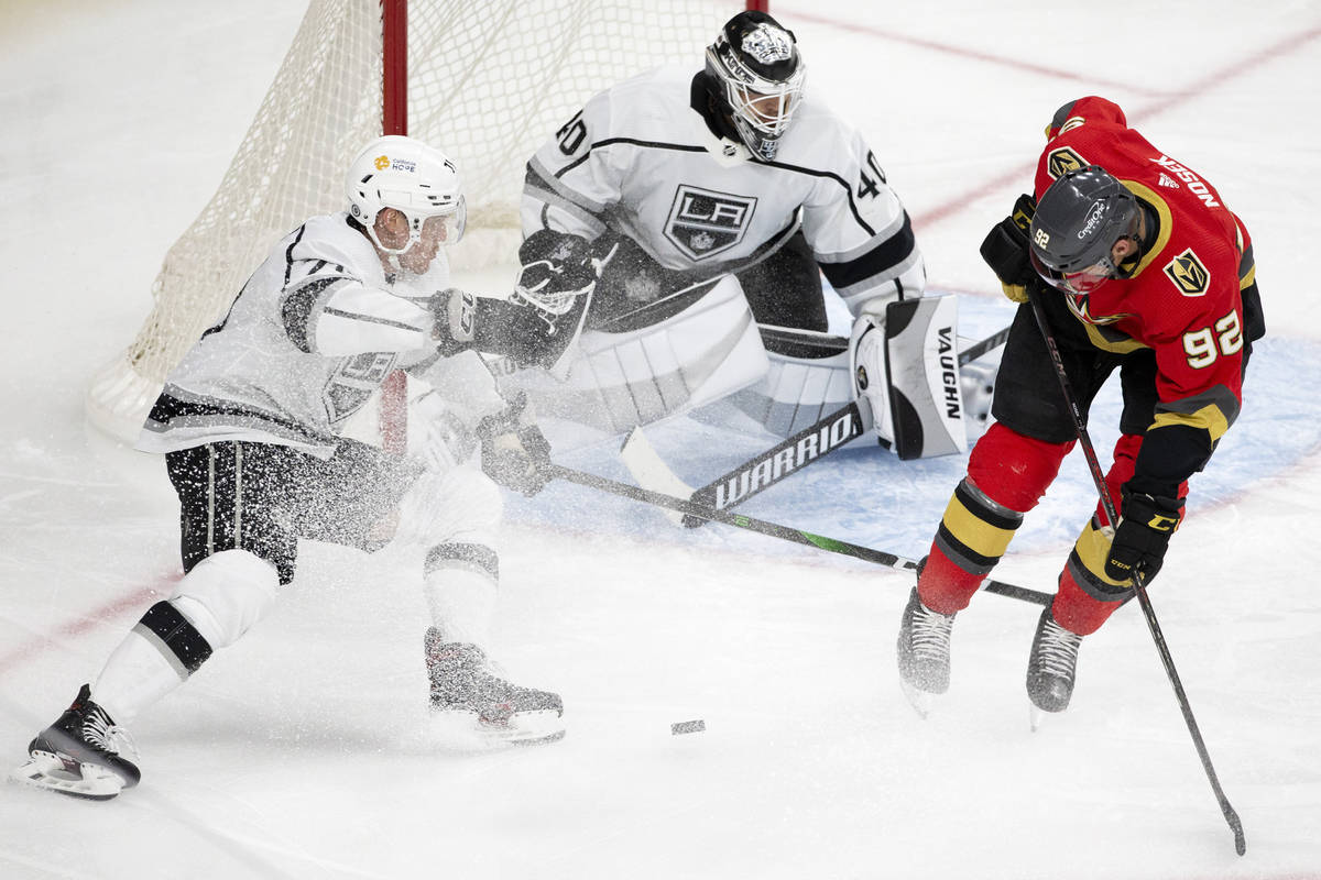 Kings defenseman Austin Strand (71) and goaltender Calvin Petersen (40) defend a shot on goal b ...
