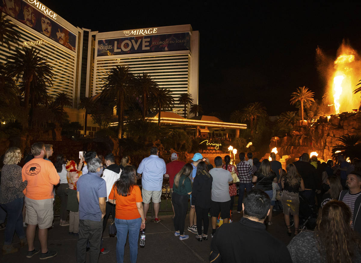 A large crowd gather to watch the volcano at The Mirage on the Strip, on Friday, March, 19, 202 ...