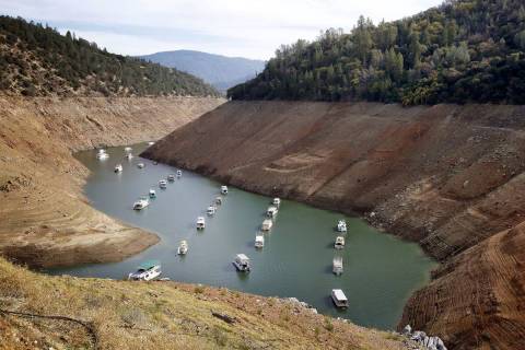 Houseboats float in the drought-lowered waters of Oroville Lake near Oroville, Calif., in Octob ...