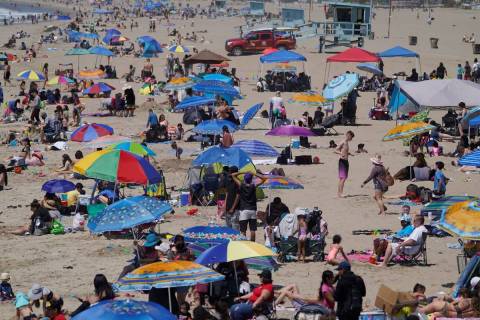 People enjoy the hot weather on Santa Monica Beach in Santa Monica, Calif., Wednesday, March 31 ...