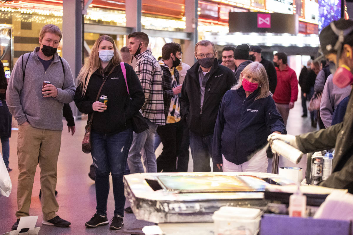 People visit the Fremont Street Experience in Las Vegas, on Friday, March 12, 2021. (Erik Verdu ...