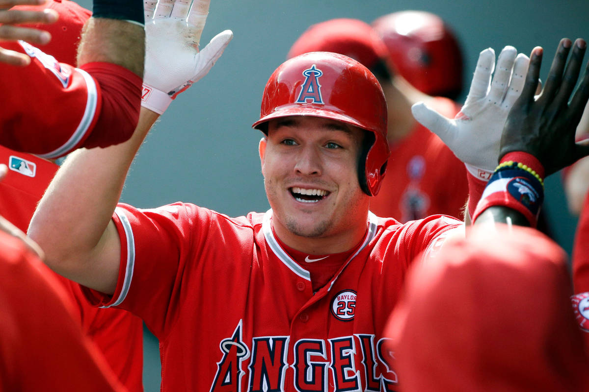 In this Sept. 10, 2017, file photo, Los Angeles Angels' Mike Trout is greeted in the dugout aft ...