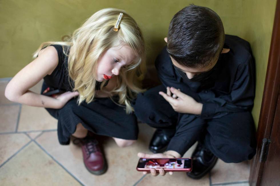 Elizabeth Swartz's great-grandniece, Ivy Laughter, and grandson, Ernie Telles, watch their matr ...