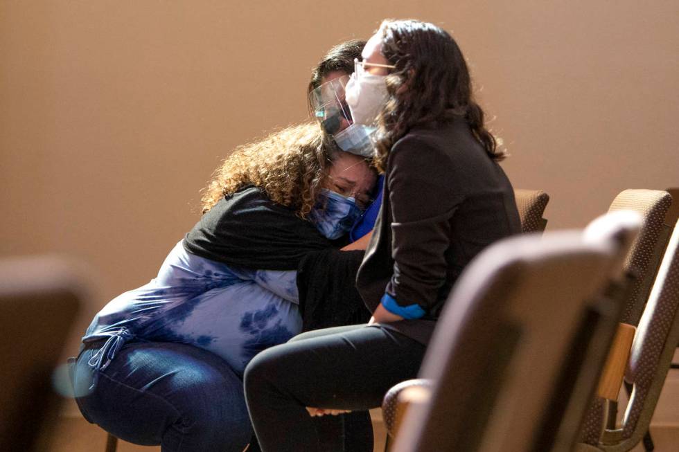 Klaudia Morales embraces her mother-in-law during the viewing for her stepson, Skyler Morales, ...