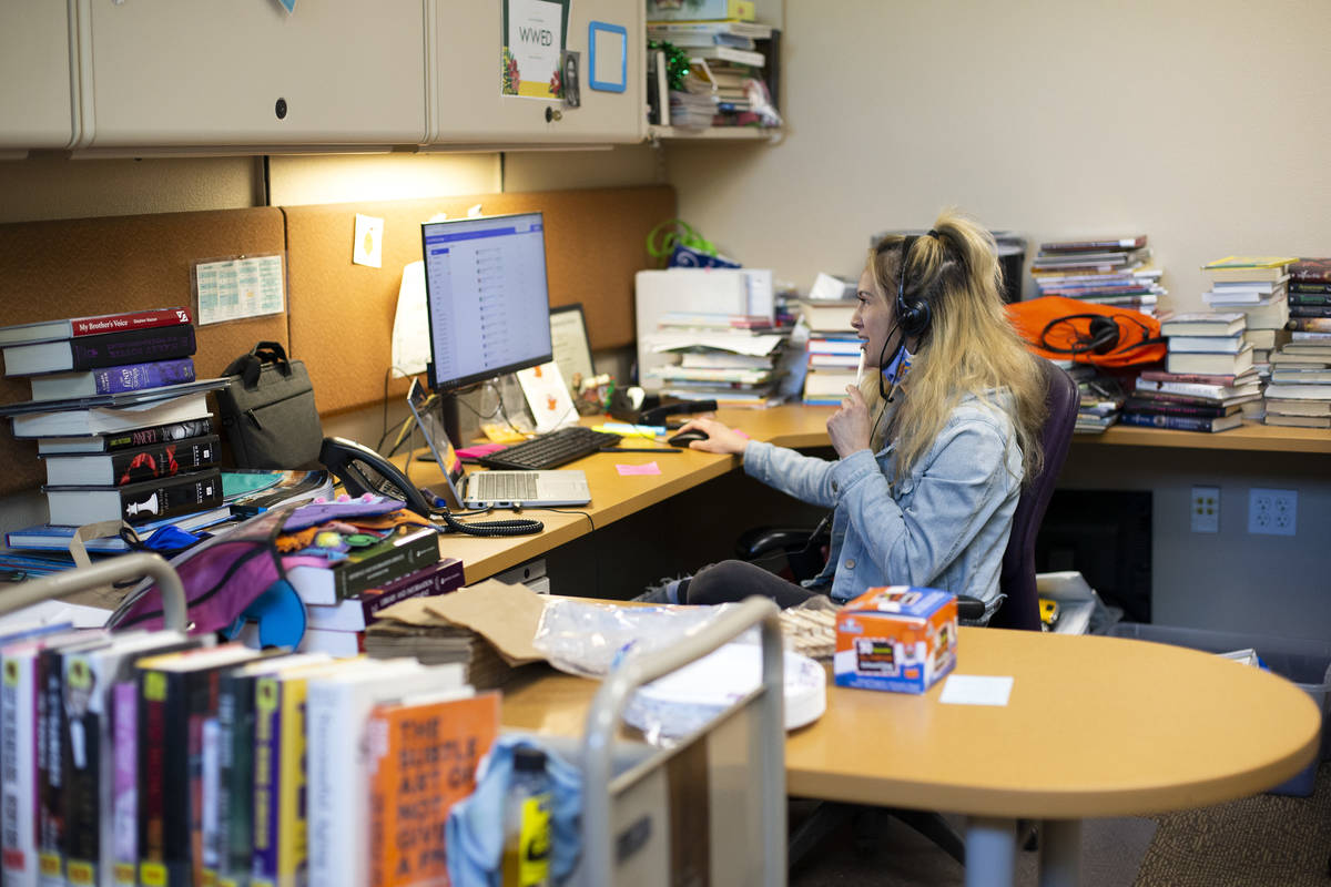 Library assistant Sonja Grace works a phone line that helps people get vaccines at Aliante Libr ...