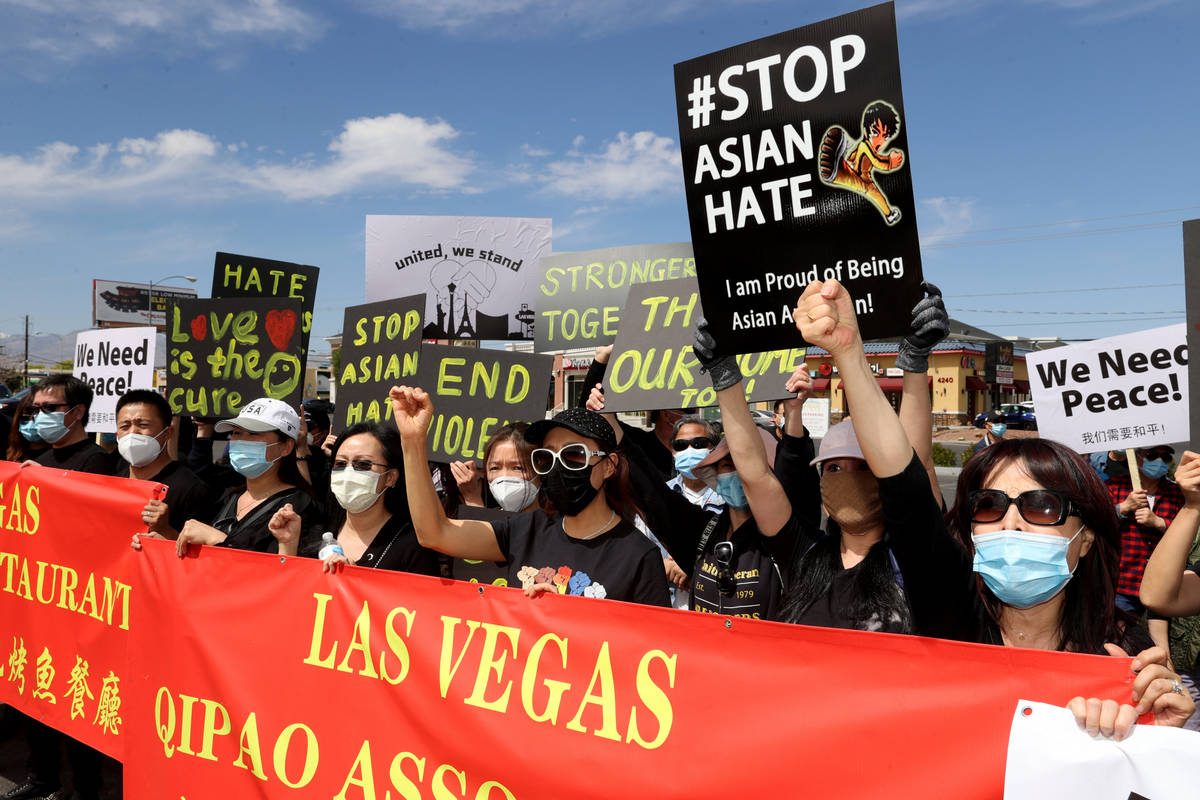 People, including Jenny Li of Las Vegas, right, rally at a "Stop Asian Hate" event at ...